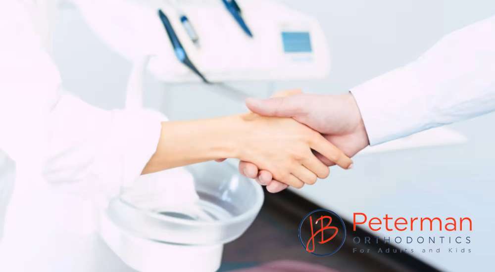 patient and dentist shake hands